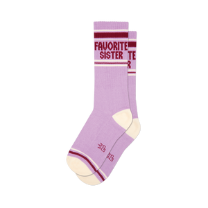Two lavender crew socks with cream heel/toe. Maroon and white stripes on cuff, 'FAVORITE SISTER' text visible on one sock.
