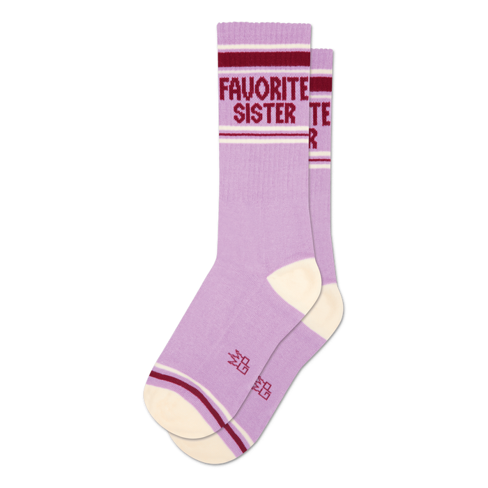 Two lavender crew socks with cream heel/toe. Maroon and white stripes on cuff, 'FAVORITE SISTER' text visible on one sock.