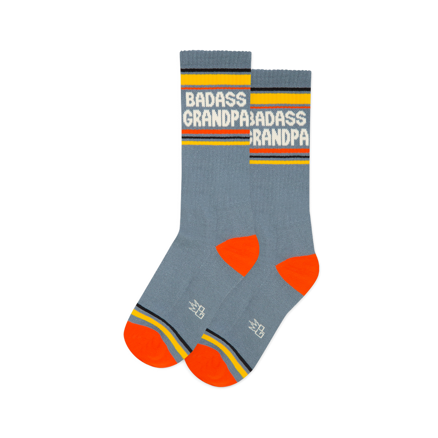 Pair of grey-blue crew socks with white "BADASS GRANDPA" text, yellow cuffs, orange heels & toes, and a grey logo.
