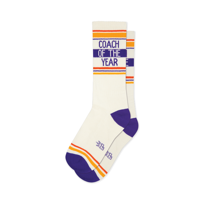 Coach of the Year cream crew socks with purple text, heel, and toe, featuring bold orange and yellow stripes on the cuff. }}