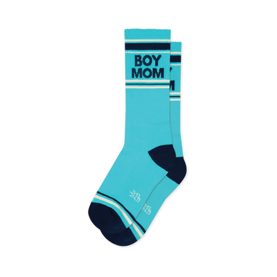 Pair of turquoise crew socks with navy blue 'BOY MOM' text, navy heels/toes, and navy and cream stripes.
