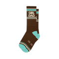 Brown crew socks with 'GIRL DAD' in white lettering, bordered by teal and off-white stripes. Features teal toe and heel, plus small white crown shapes.
