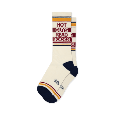 Cream crew socks with 'Hot Guys Read Books' text in red, yellow, and navy stripes, dark blue toe and heel.