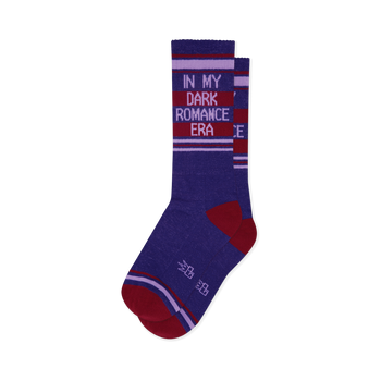 Pair of deep purple crew socks with 'IN MY DARK ROMANCE ERA' text in light purple on dark red stripes. Red toe, heel, and accent stripes.