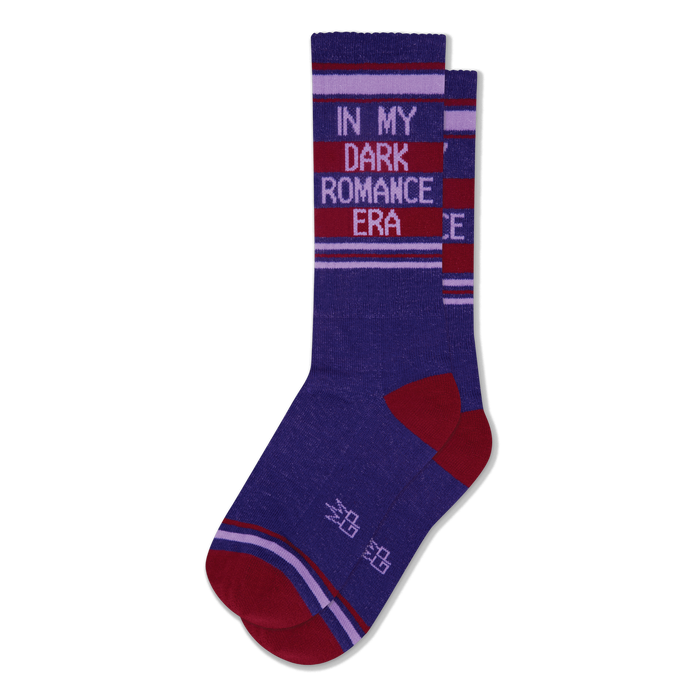 Pair of deep purple crew socks with 'IN MY DARK ROMANCE ERA' text in light purple on dark red stripes. Red toe, heel, and accent stripes. }}