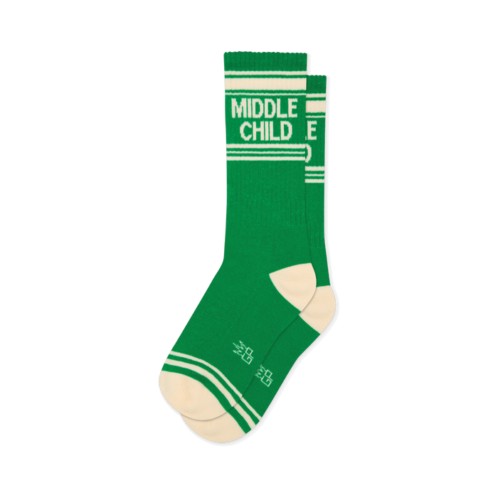 Green athletic crew socks with white stripes, cream toes, and bold text reading MIDDLE CHILD on the upper calf. }}
