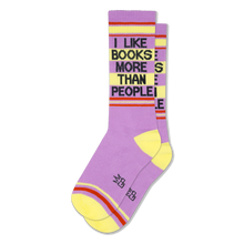 Lavender crew socks with yellow heels and toes, featuring the phrase I LIKE BOOKS MORE THAN PEOPLE in black block letters.