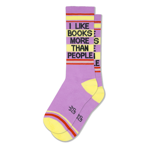 Lavender crew socks with yellow heels and toes, featuring the phrase I LIKE BOOKS MORE THAN PEOPLE in black block letters.