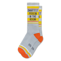 Light grey ribbed socks featuring orange heels, yellow bands, white stripes, and SMARTEST PERSON IN THE ROOM on the calf.