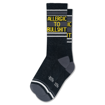 Dark heathered crew socks with grey heels and toes, white stripes, and bright yellow text reading ALLERGIC TO BULLSHIT.
