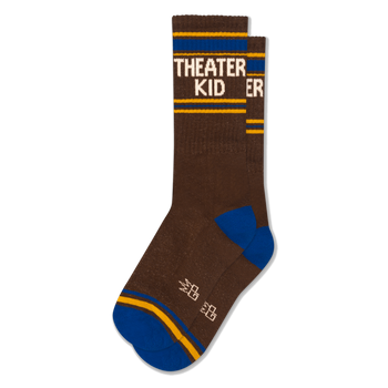Brown crew socks with THEATER KID in white block letters, featuring royal blue and yellow stripes on the cuff and toe.