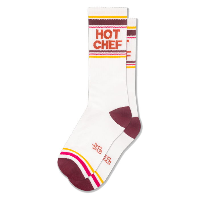 White athletic crew socks with HOT CHEF in bold orange letters, featuring retro stripes in maroon, yellow, pink, and white. }}