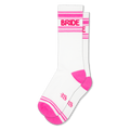 White athletic crew socks with a bright pink heel and toe, pink stripes, and the word BRIDE in pink text across the calf.