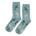 Light blue crew socks featuring a scattered pattern of dark blue whales and grey spotted narwhals with striped tusks.