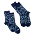 Two pairs of dark blue socks with light blue zodiac signs and purple stars, laid flat against a black background.