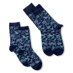 Two pairs of dark blue socks with light blue zodiac signs and purple stars, laid flat against a black background.