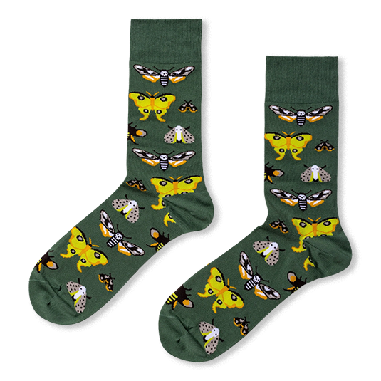 Dark green crew socks featuring a pattern of varied moths, including bright yellow ones and dark ones with skull markings.
