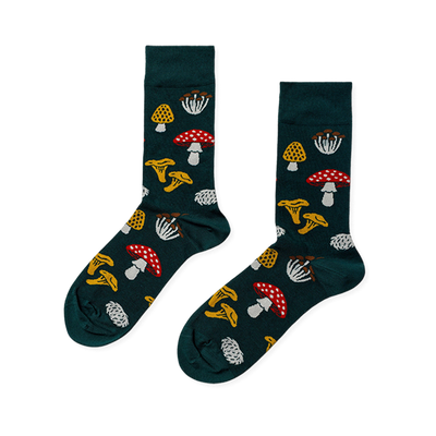 Pair of crew socks in dark green, patterned with various fungi: red with white spots, yellow ruffled, white clusters, and textured yellow mushrooms.