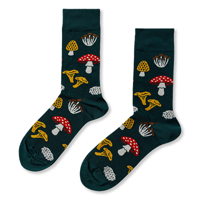 Pair of crew socks in dark green, patterned with various fungi: red with white spots, yellow ruffled, white clusters, and textured yellow mushrooms.