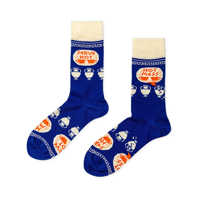 Pair of royal blue crew socks with cream cuffs, heels, toes. Features 'Serve Hot' and 'Hot Mess' text with cups and broken Greek vases.