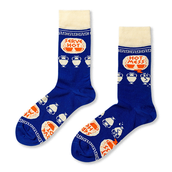 Pair of royal blue crew socks with cream cuffs, heels, toes. Features 'Serve Hot' and 'Hot Mess' text with cups and broken Greek vases.