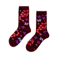 Pair of burgundy crew socks with red cats, white floral patterns, white bows, purple flowers, and white butterflies.