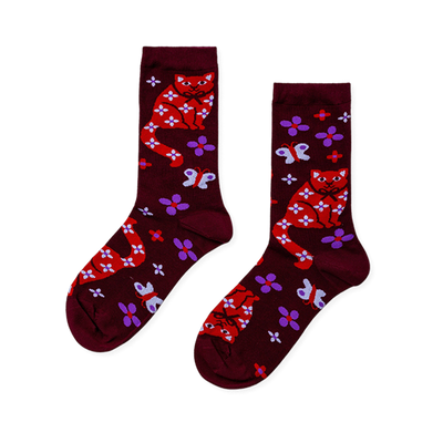 Pair of burgundy crew socks with red cats, white floral patterns, white bows, purple flowers, and white butterflies.