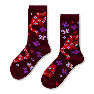 Pair of burgundy crew socks with red cats, white floral patterns, white bows, purple flowers, and white butterflies.