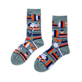 Pair of crew socks in sage green with a bookshelf pattern. Design includes books, a white cat, plants, and reading glasses.