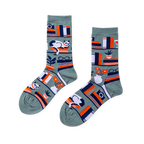 Pair of crew socks in sage green with a bookshelf pattern. Design includes books, a white cat, plants, and reading glasses.