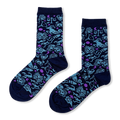 Navy blue crew socks with a scattered pattern of light blue zodiac signs and small purple crescent moons and stars.