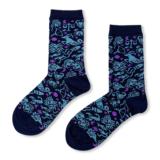 Navy blue crew socks with a scattered pattern of light blue zodiac signs and small purple crescent moons and stars.