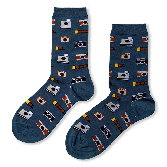 Pair of slate blue crew socks featuring a pattern of vintage cameras in brown and grey, plus yellow and black film rolls.