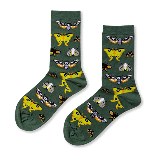 Pair of crew socks in dark green, patterned with various moths including yellow, black and white skull-like, and grey speckled designs. }}