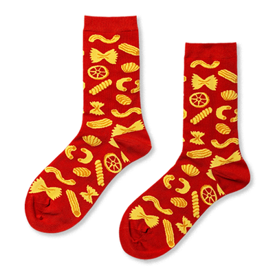 Pair of red crew socks covered in a cheerful yellow pattern of various pasta shapes, including farfalle and penne.