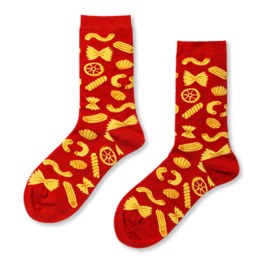 Pair of red crew socks covered in a cheerful yellow pattern of various pasta shapes, including farfalle and penne. }}