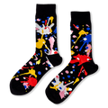Black crew socks with bright, messy paint splatters in red, blue, yellow, pink, and white.