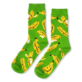 Bright green crew socks covered in a pattern of yellow bananas with tiny smiling faces, some peeled and some unpeeled.
