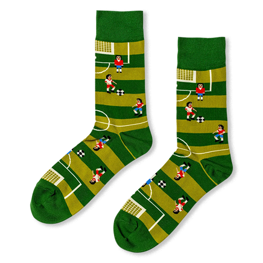 Green crew socks with a retro 8-bit soccer pitch design, showing white field lines, tiny pixelated players, and goals.