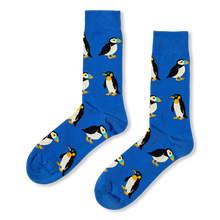 Royal blue crew socks featuring a repeating pattern of puffins with colorful beaks and penguins with yellow neck markings.