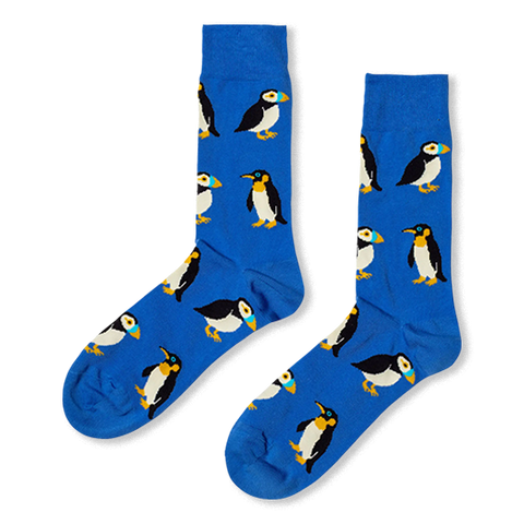 Royal blue crew socks featuring a repeating pattern of puffins with colorful beaks and penguins with yellow neck markings.