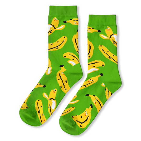 Bright green crew socks with a pattern of yellow bananas, some peeled and some unpeeled, featuring tiny smiling faces.