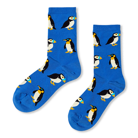 Bright blue crew socks featuring a repeating pattern of puffins and penguins with black, white, and yellow details.