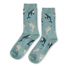 Light blue crew socks with a repeating pattern of dark blue whales and light grey spotted narwhals.