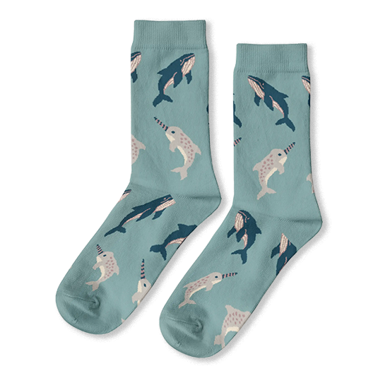 Light blue crew socks with a repeating pattern of dark blue whales and light grey spotted narwhals.
