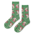 Light green crew socks featuring a pattern of floating pink axolotls with bright magenta gills and tiny black eyes.