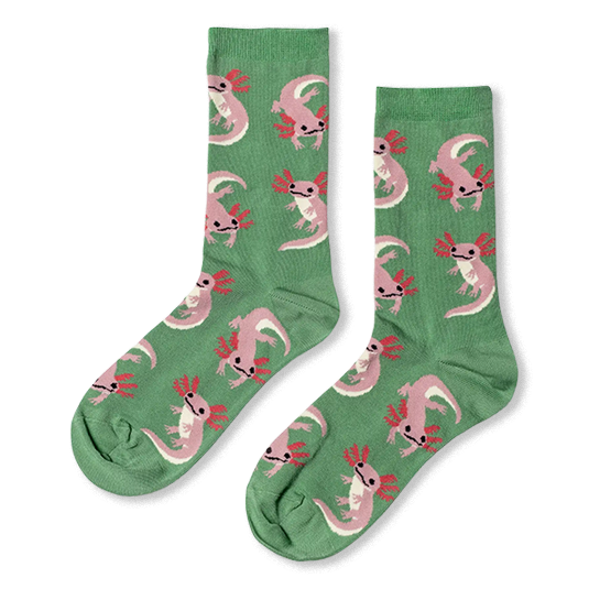 Light green crew socks featuring a pattern of floating pink axolotls with bright magenta gills and tiny black eyes.