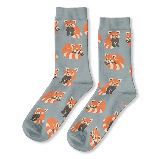 Light blue crew socks featuring an all-over pattern of red pandas with striped tails in sitting and sleeping poses.
