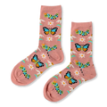A pair of dusty pink crew socks showing a pattern of blue butterflies, green caterpillars, white daisies, and blue stems.