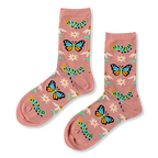 A pair of dusty pink crew socks showing a pattern of blue butterflies, green caterpillars, white daisies, and blue stems.